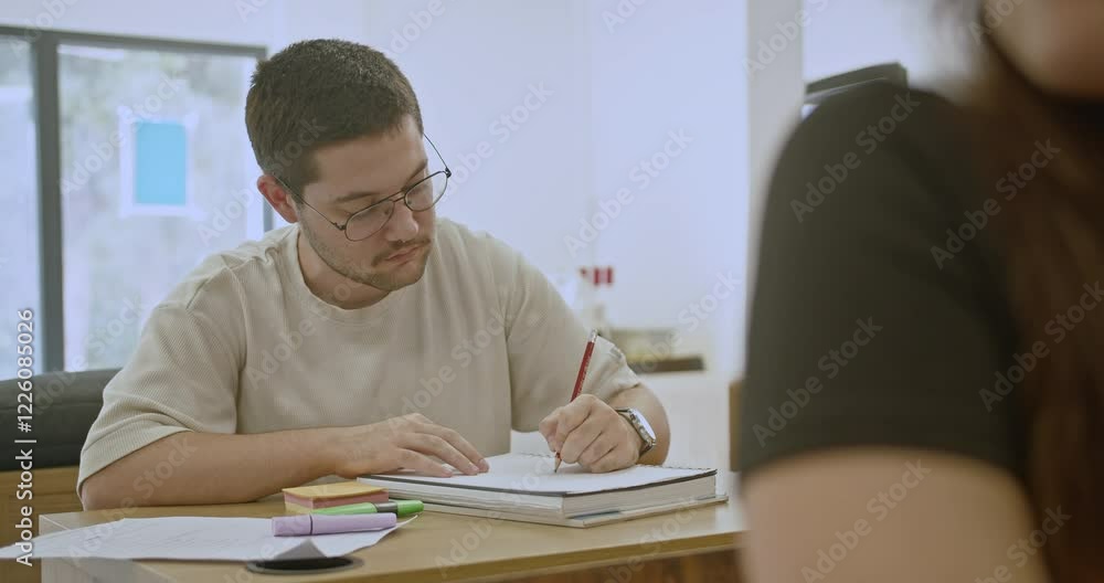 High school student focused on taking notes, collaborating with classmates in a modern classroom setting, demonstrating teamwork and learning. High school student focused on taking notes, collaborating with classmates in a modern classroom setting, demonstrating teamwork and learning.