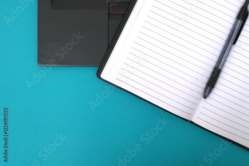 Note book, bolpoin on laptop keyboard