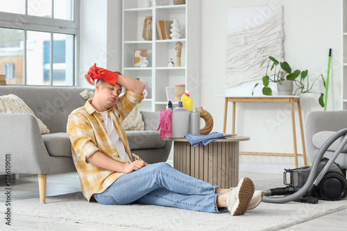 Tired young man sitting on ...