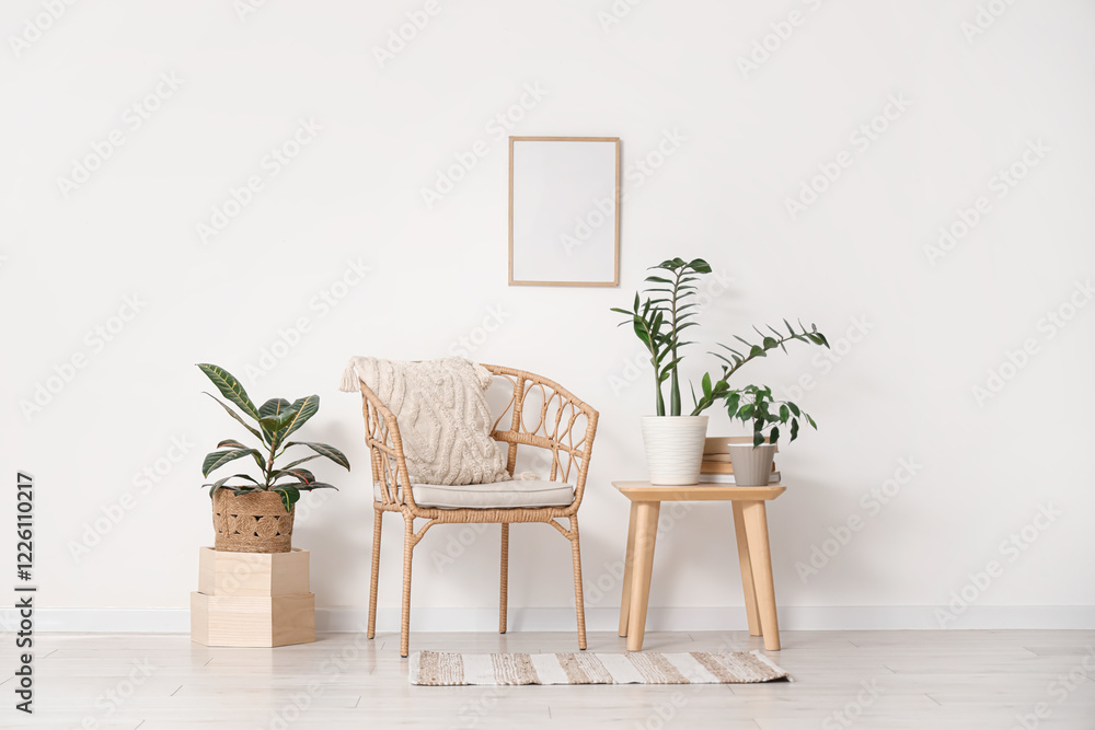 Interior of light room with armchair, table and green plants Interior of light room with armchair, table and green plants