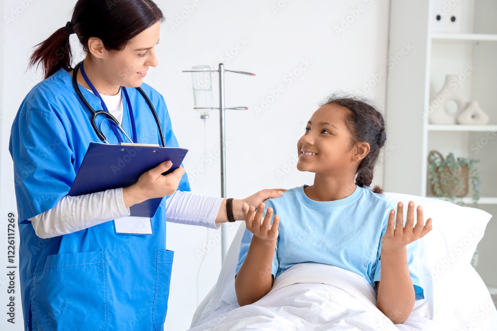 Teenage African-American girl talking to doctor in hospital room Teenage African-American girl talking to doctor in hospital room