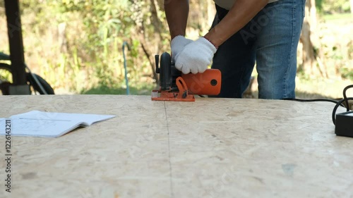 Wallpaper Mural A carpenter cuts wood panels with a circular saw to make eco-friendly furniture. Torontodigital.ca
