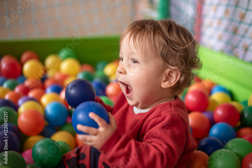Excited baby in ball pool