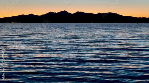 Wallpaper Mural Breathtaking sunset paints the sky in vibrant hues over Lake Havasu, casting a golden glow across the tranquil waters as the California shoreline silhouettes against the horizon. Torontodigital.ca