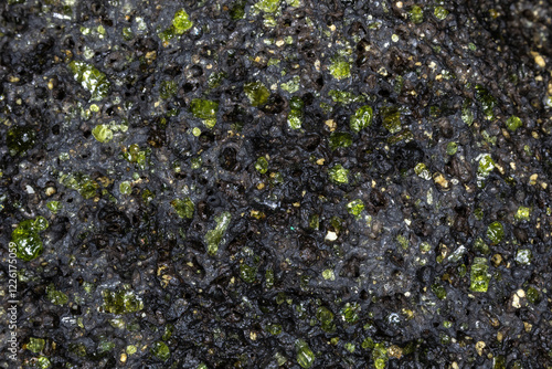 Closeup, raw peridot in volcanic rock matrix. From beach on the island of Hawaii, near South Point. 
 photo