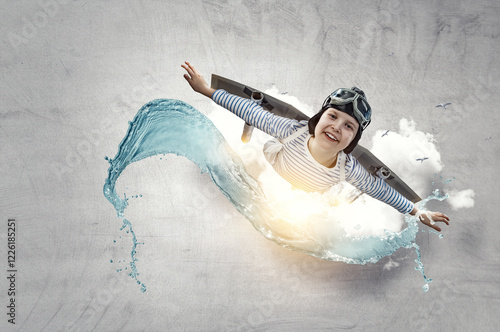 Happy little boy flying wearing helmet