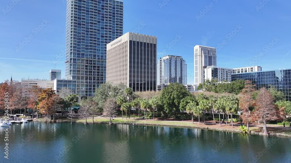 Eola Park At Orlando Florida United States. Aerial View Of A Bustling Downtown Cityscape With Modern Buildings. Business Sky Downtown Cityscape. Backgrounds Panning Wide. Orlando Florida. Eola Park At Orlando Florida United States. Aerial View Of A Bustling Downtown Cityscape With Modern Buildings. Business Sky Downtown Cityscape. Backgrounds Panning Wide. Orlando Florida.