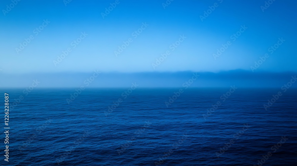 Fototapeta premium Serene Ocean Mist Under a Blue Sky