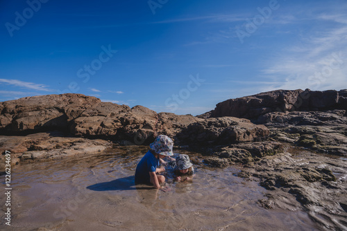 Two kids exploring rock pools