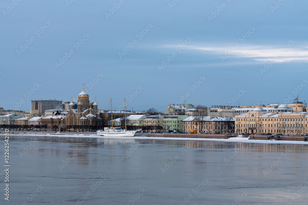 Embankment of Lieutenant Schmidt and the Church of the Assumption of the Blessed Virgin Mary (Assumption Church) on the banks of the Neva River on a winter day, Saint Petersburg, Russia Embankment of Lieutenant Schmidt and the Church of the Assumption of the Blessed Virgin Mary (Assumption Church) on the banks of the Neva River on a winter day, Saint Petersburg, Russia