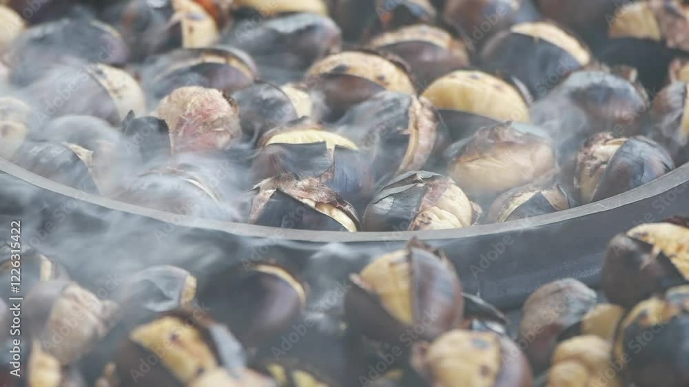 Roasting chestnuts at a local market in autumn season Roasting chestnuts at a local market in autumn season
