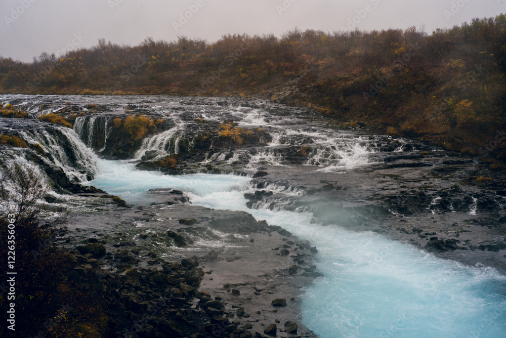 Brúarfoss Waterfall in Iceland, known for its stunning turquoise water, cascades over rugged volcanic rock, creating a mesmerizing and picturesque natural wonder Brúarfoss Waterfall in Iceland, known for its stunning turquoise water, cascades over rugged volcanic rock, creating a mesmerizing and picturesque natural wonder