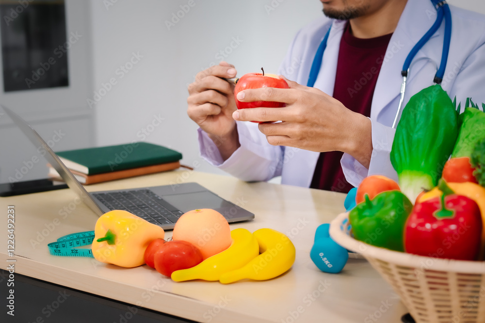 A male nutritionist sitting at a table, advising on healthy diets, promoting vegetable-based meals, supplements, weight loss, and meal planning to improve overall health and well-being A male nutritionist sitting at a table, advising on healthy diets, promoting vegetable-based meals, supplements, weight loss, and meal planning to improve overall health and well-being