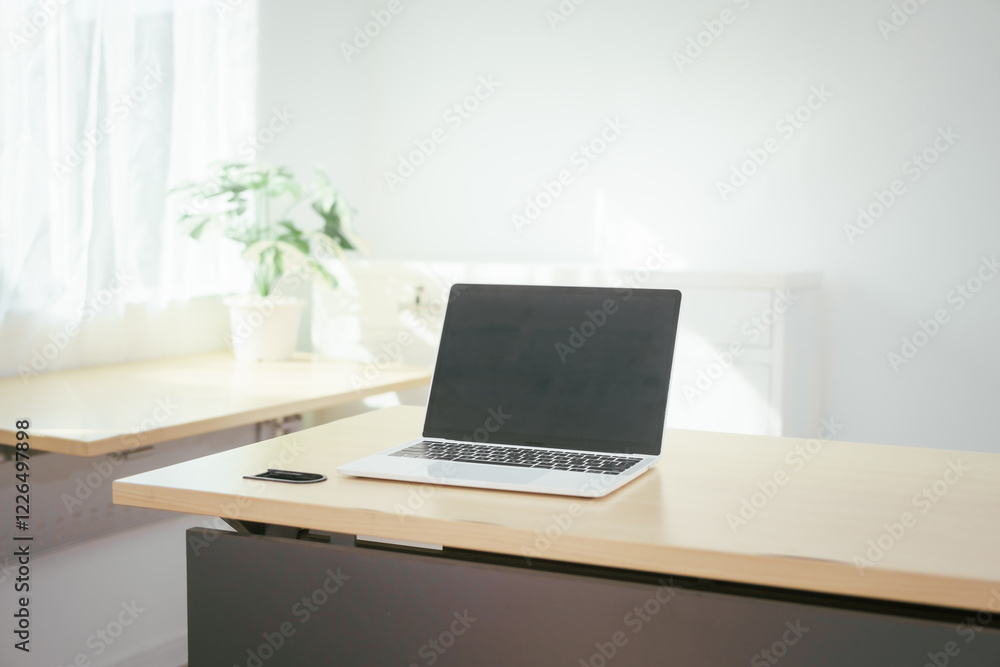 Fototapeta premium A computer is placed on the table, representing a modern workspace for digital tasks, online communication, research, creativity, or professional work in an organized and functional environment