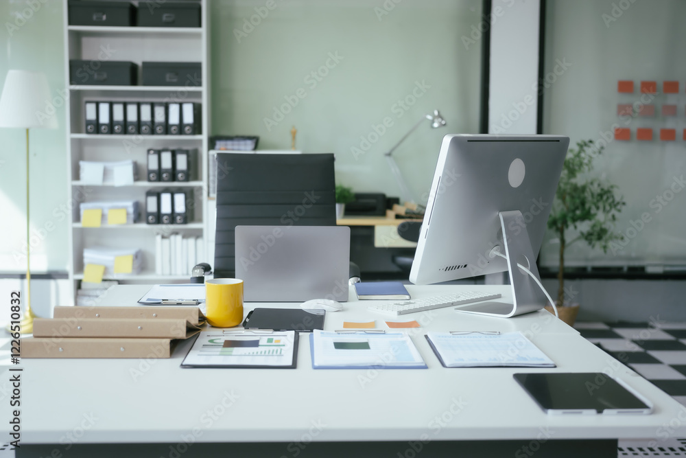 An office desk with a computer, documents, and graphs represents a workspace for professionals analyzing data, managing reports,making strategic decisions in business, finance, or administration An office desk with a computer, documents, and graphs represents a workspace for professionals analyzing data, managing reports,making strategic decisions in business, finance, or administration
