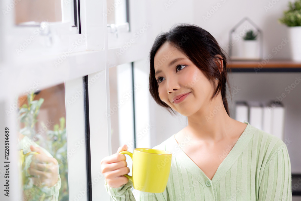 Portrait young asian woman relax and enjoyment with drinking coffee by the window in living room at home, woman smiling with happiness and comfortable drinking beverage at home, lifestyle and leisure. Portrait young asian woman relax and enjoyment with drinking coffee by the window in living room at home, woman smiling with happiness and comfortable drinking beverage at home, lifestyle and leisure.