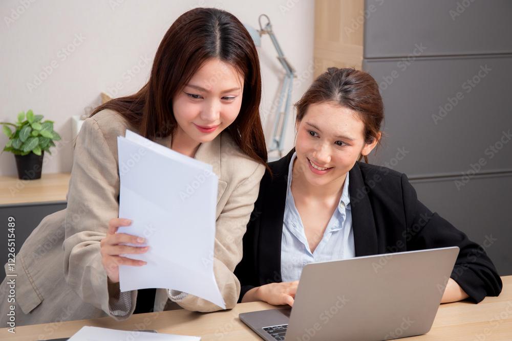 Two businesswoman working together about project while looking document on paperwork in modern office, two business woman planning and strategy about financial and meeting, business and marketing. Two businesswoman working together about project while looking document on paperwork in modern office, two business woman planning and strategy about financial and meeting, business and marketing.