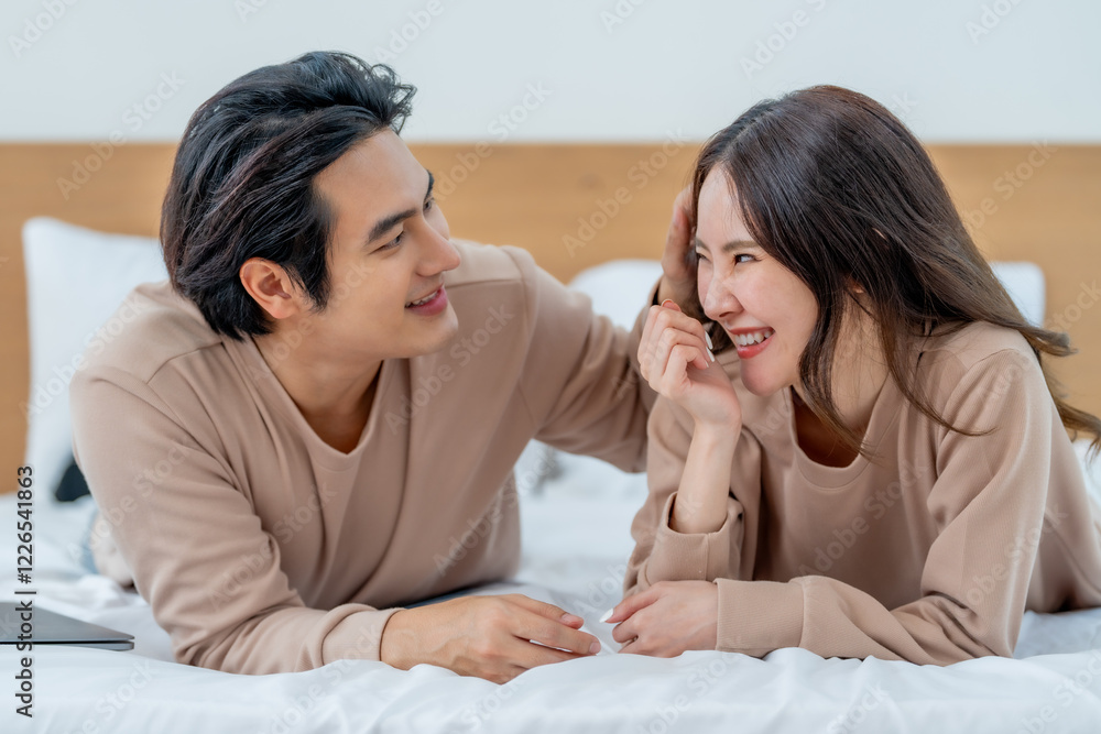 Happy couple enjoying time together in bed, sharing laughter and affection. Their cozy atmosphere reflects love and connection Happy couple enjoying time together in bed, sharing laughter and affection. Their cozy atmosphere reflects love and connection