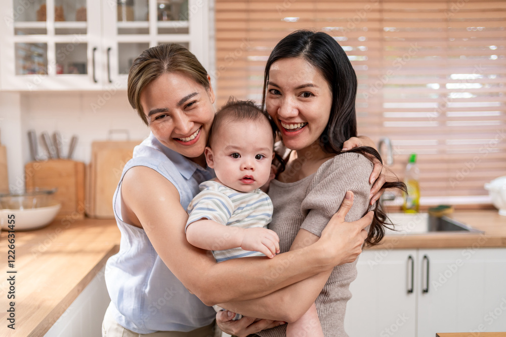 Portrait of Asian lesbian couple caring for and raising baby boy at home. Portrait of Asian lesbian couple caring for and raising baby boy at home.