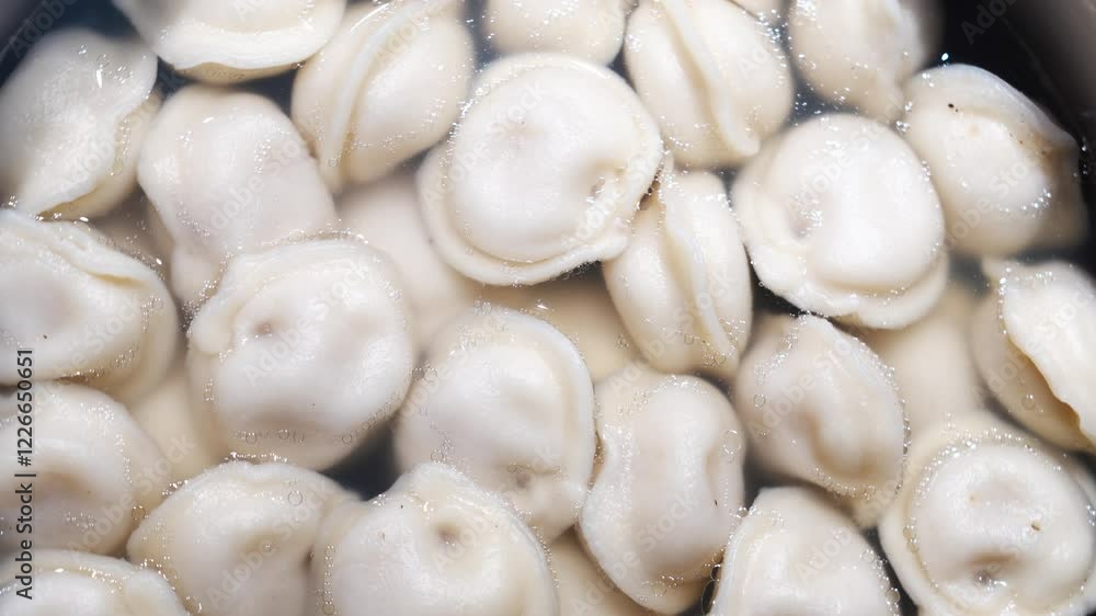 rotation. Boiled dumplings with broth in a saucepan. View from above. A simple and quick meal for lunch with the whole family. Foods. rotation. Boiled dumplings with broth in a saucepan. View from above. A simple and quick meal for lunch with the whole family. Foods.
