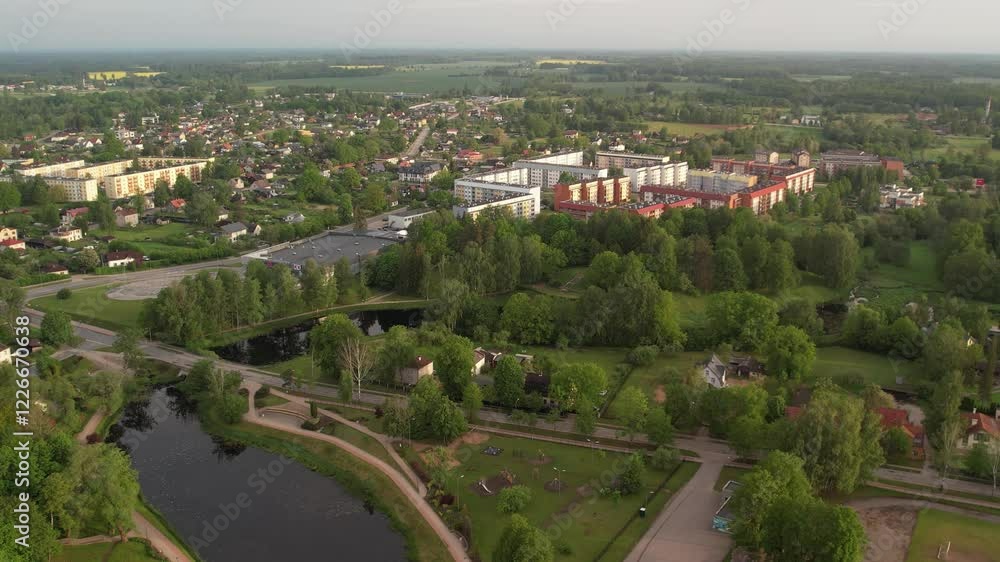 Peaceful Aerial View of Residential Area Surrounded by Greenery and Water, Latvia. City Valmiera Peaceful Aerial View of Residential Area Surrounded by Greenery and Water, Latvia. City Valmiera