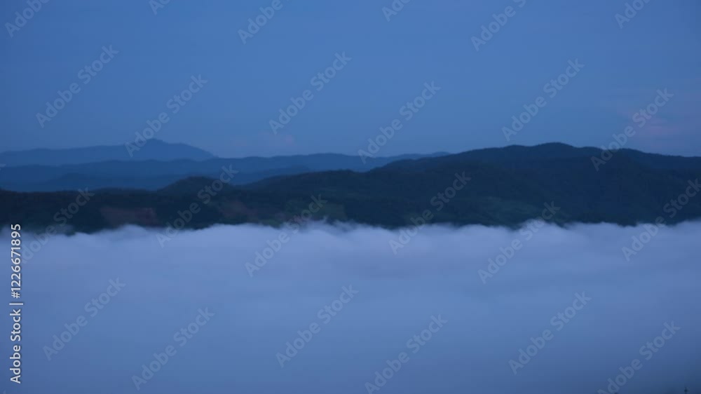 Landscape view of the sea of fog flowing on hills at dawn Landscape view of the sea of fog flowing on hills at dawn
