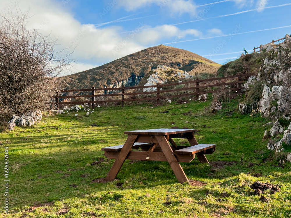 Wooden picnic table in a scenic mountain landscape Wooden picnic table in a scenic mountain landscape