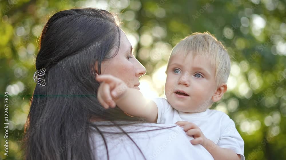 Mom play with son outdoors. joyful family moment as mom holds son. Playful interaction between mom and son in nature. Happy family bonding during play. Loving mom and son connection in family setting. Mom play with son outdoors. joyful family moment as mom holds son. Playful interaction between mom and son in nature. Happy family bonding during play. Loving mom and son connection in family setting.