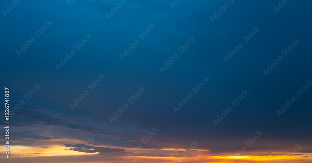 Obraz premium Sunrise background. Dramatic majestic scenery sunset. Sky with clouds in Sunrise sky light background. Sunrise with clouds in various shapes. Calm Sunrise sky and sun through clouds over.