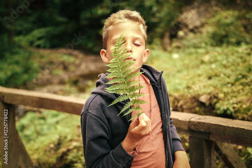 Wild child holding wild fern photo