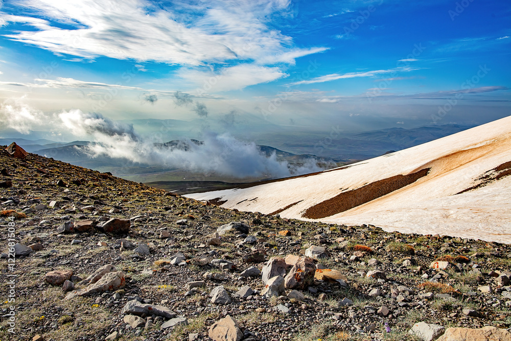 Majestic mountain landscape showcasing a rocky terrain and stunning cloud patterns