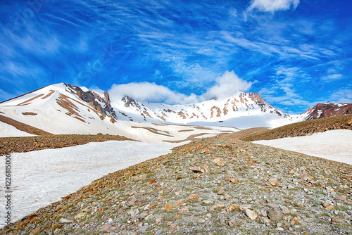 Obraz na płótnie Majestic snow-capped mountains under a brilliant blue sky at midday in a tranquil landscape w salonie
