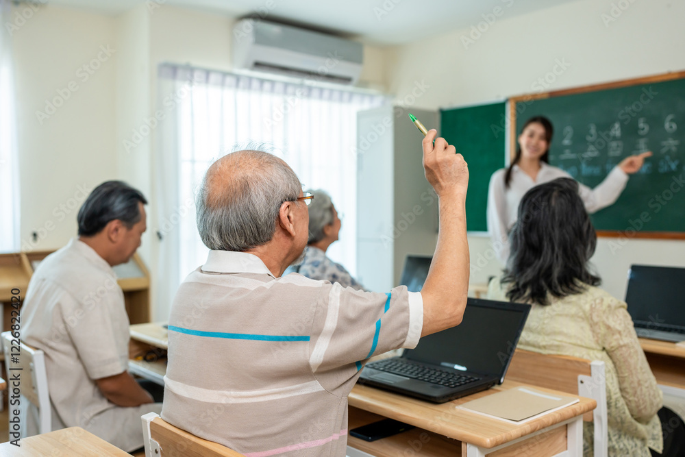 Group of Asian mature students study with instructor in class at school. Group of Asian mature students study with instructor in class at school.
