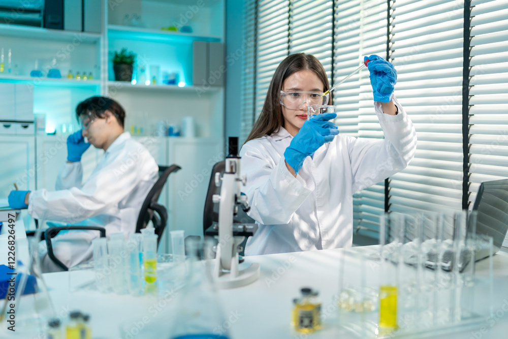 Asian female scientist working in biotechnology research laboratory. Asian female scientist working in biotechnology research laboratory.