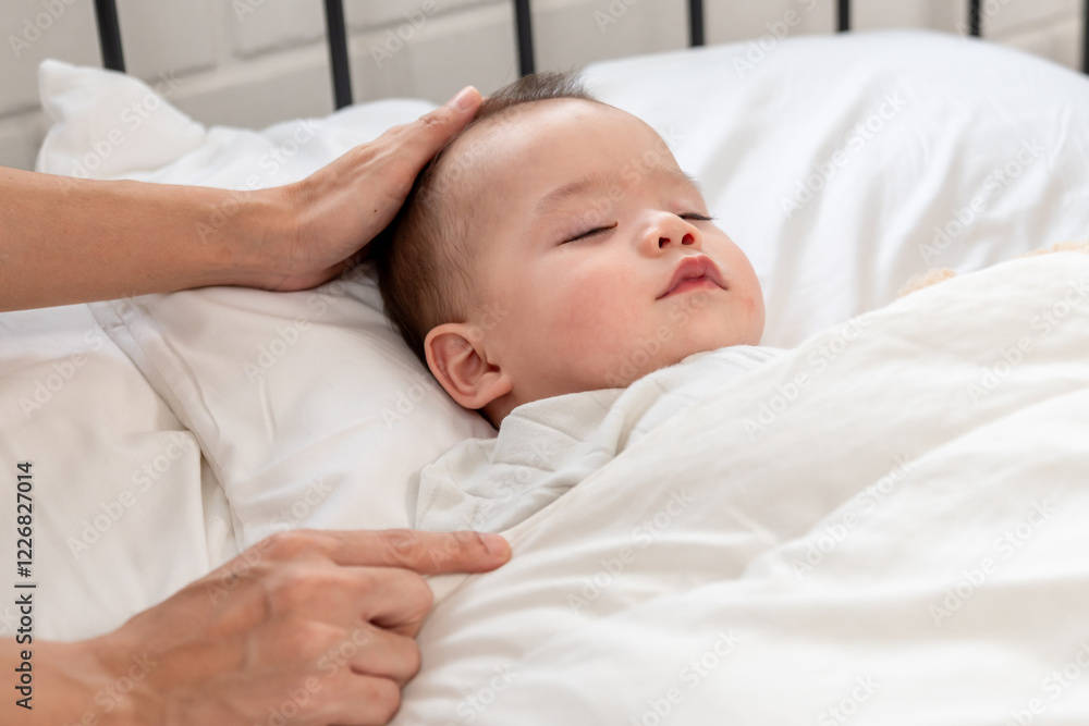 Close up hands of mother put blanket on sleeping baby boy with gently. Close up hands of mother put blanket on sleeping baby boy with gently.