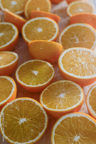 Half-cut oranges on a cutting board. slice. close up and vertical photograhy