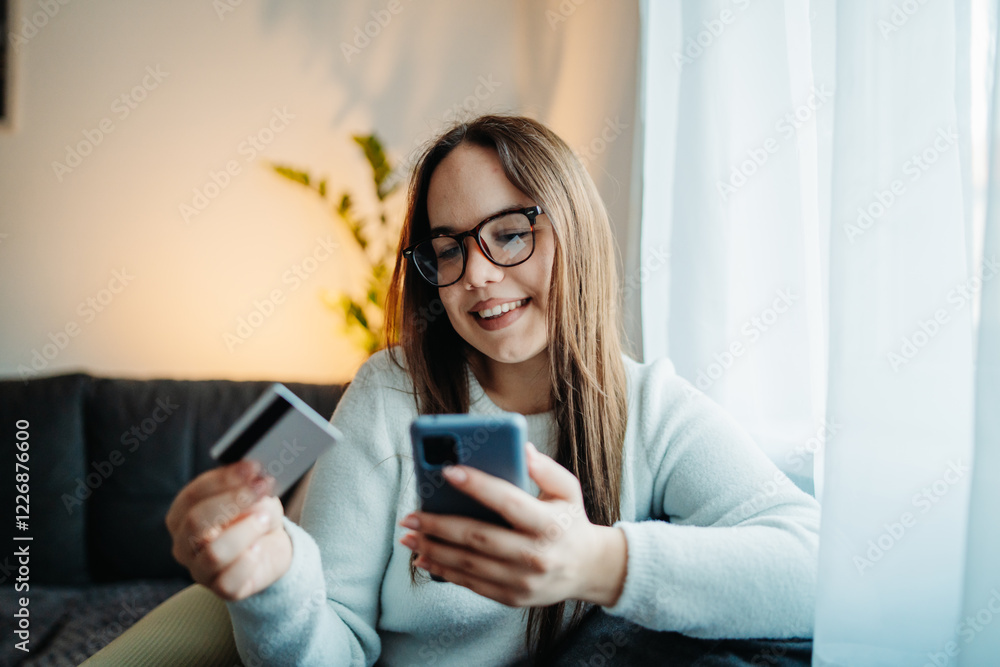 Young caucasian woman buying online on smart phone using credit card
Young caucasian woman buying online on smart phone using credit card