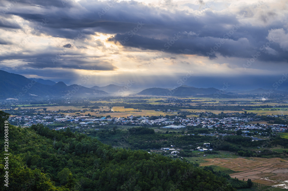 Fototapeta premium top view of rice fields with villages against background of mountains in Vietnam in Asia in the evening.