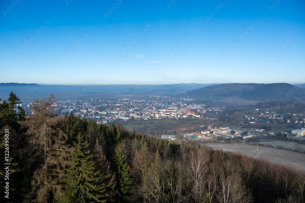 Aerial view of Moravska Trebova with its scenic panorama. The town is surrounded by rolling hills and dense forests, showcasing the harmony of historic architecture and Czech nature