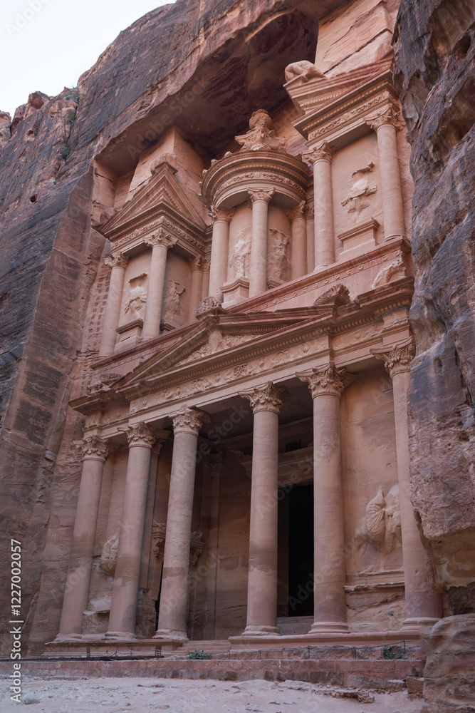 Fototapeta premium The iconic Al Khazneh in Petra, Jordan, showing intricate carvings and stunning architectural details. Travel, architecture, and archaeological themes.