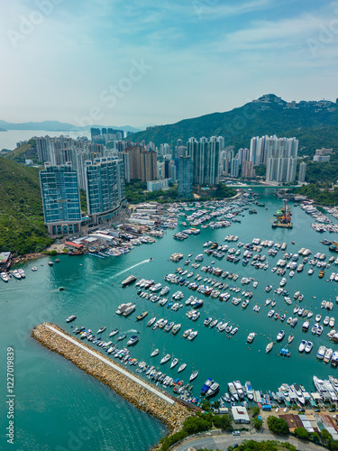 Vertical aerial view of apartment buildings and marina in Hong Kong