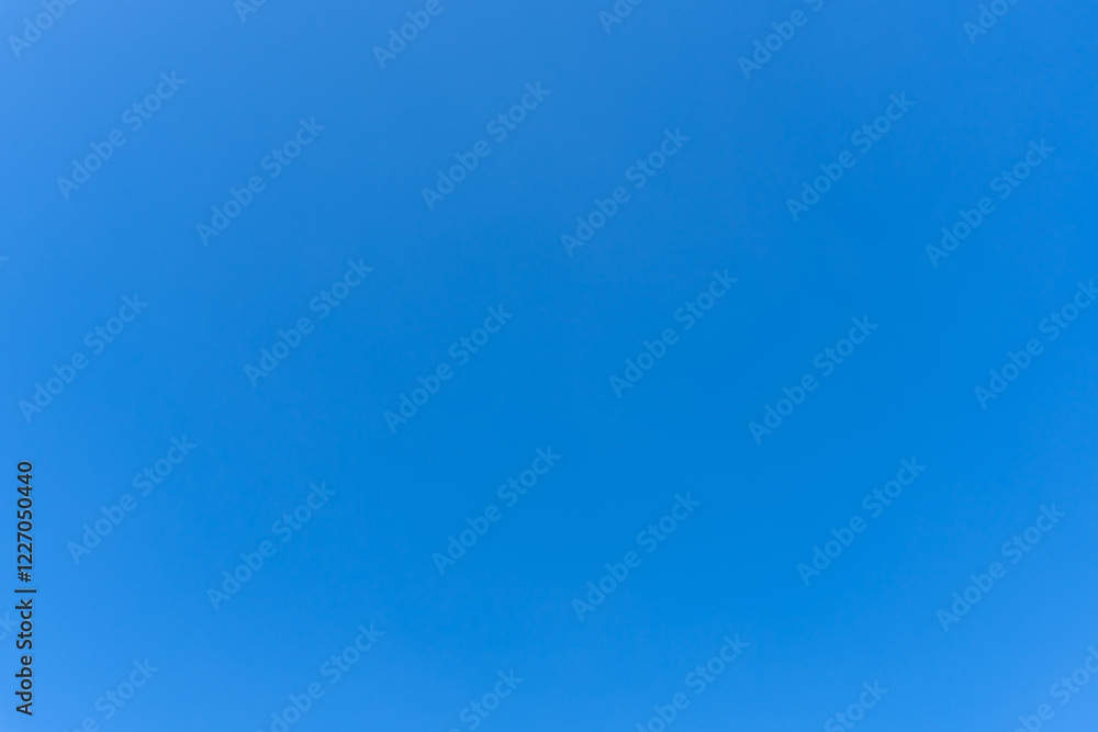Naklejka premium Low angle view and full frame of beautiful light blue sky without clouds in the morning or afternoon on sunny day used as natural background texture in decorative art work