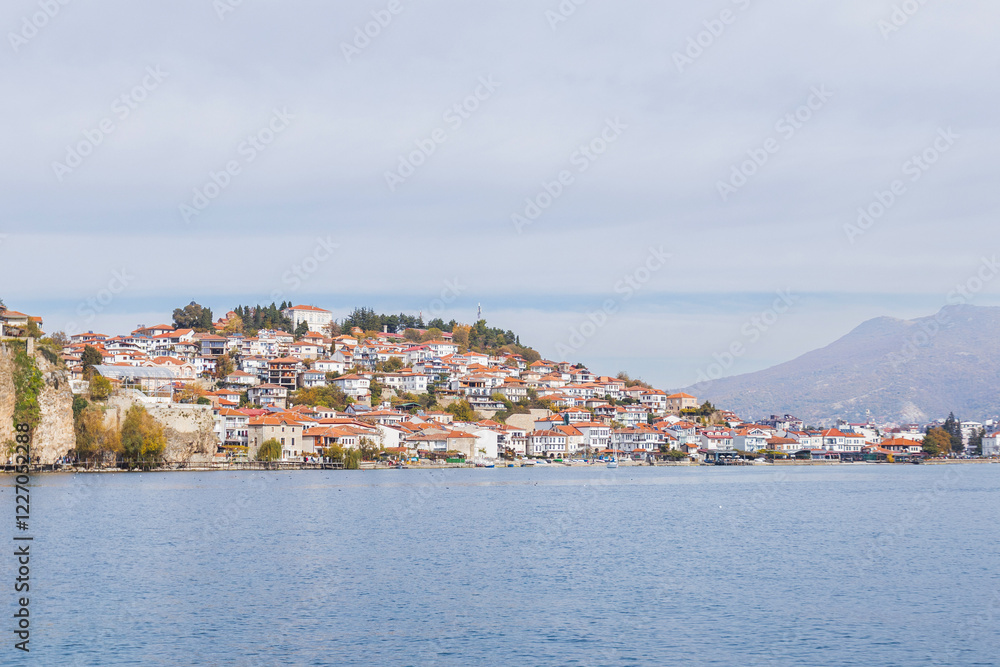 Obraz premium Picturesque view of Ohrid, North Macedonia, a historic town on Lake Ohrid shore, known for its charming architecture and stunning lake views, making it a popular tourist destination.