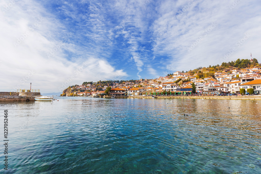 Fototapeta premium Picturesque view of Ohrid, North Macedonia, a historic town on Lake Ohrid shore, known for its charming architecture and stunning lake views, making it a popular tourist destination.