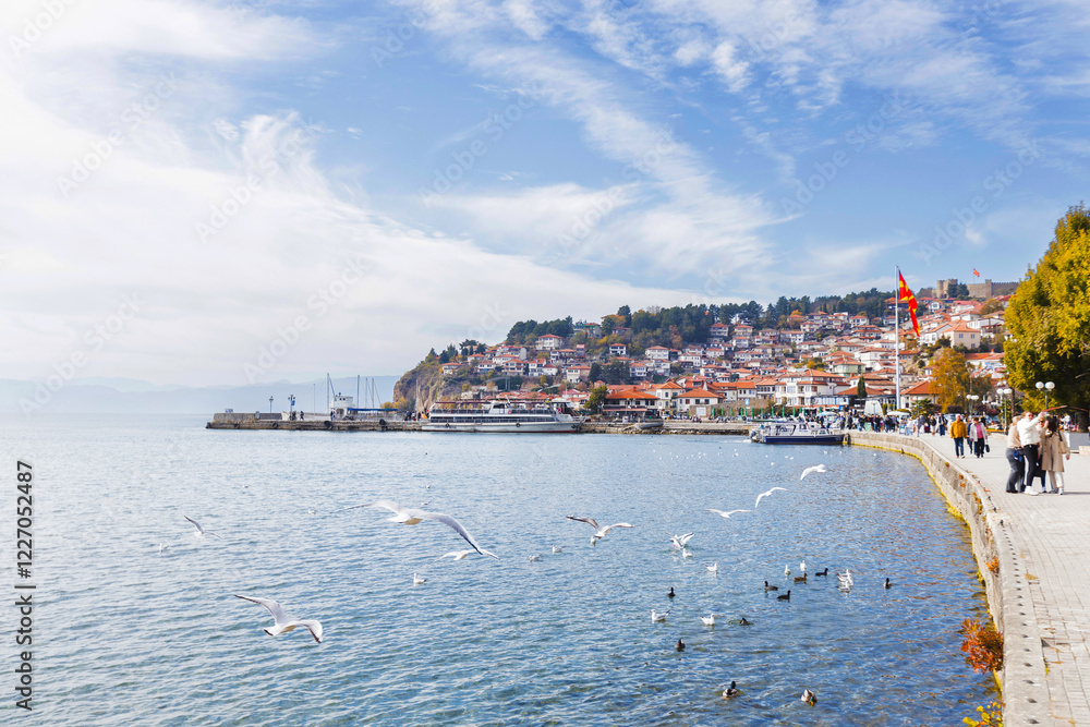 Obraz premium Picturesque view of Ohrid, North Macedonia, a historic town on Lake Ohrid shore, known for its charming architecture and stunning lake views, making it a popular tourist destination.