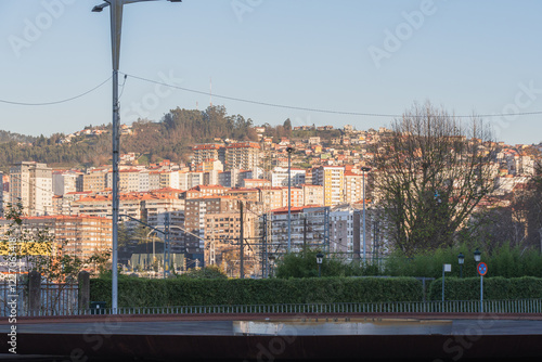 Enchanting Winter Evening Sunset in East Vigo – Warm Sunshine over Coastal Cityscape