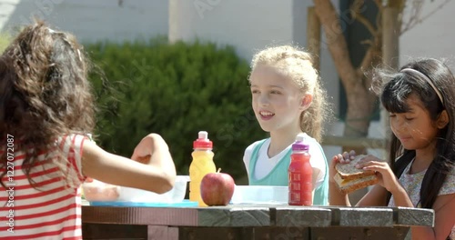 Wallpaper Mural In school, group of children eating lunch together at outdoor table Torontodigital.ca