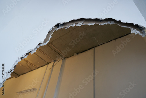 Broken drywall, a background crack with a white wall texture. With space to copy. High quality photo