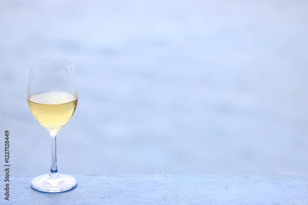 a glass of white wine on the background of the sea relaxing by the sea with wine a glass of white wine on the background of the sea relaxing by the sea with wine