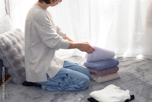 洗濯物を畳む女性のイメージ
